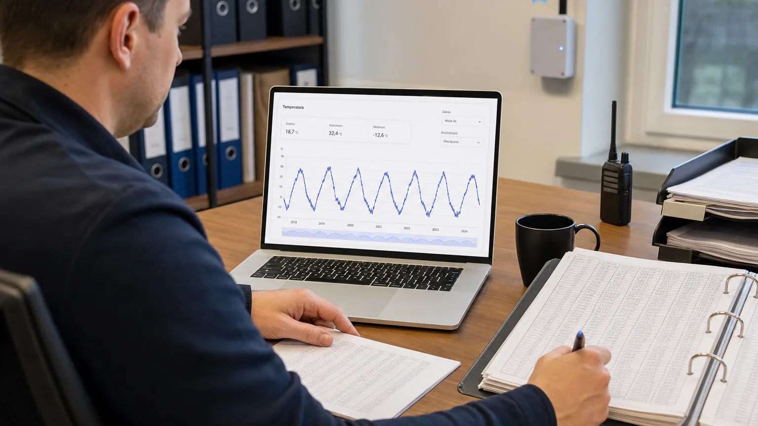 An auditor compares years of temperature measurement history on screen with paper documentation